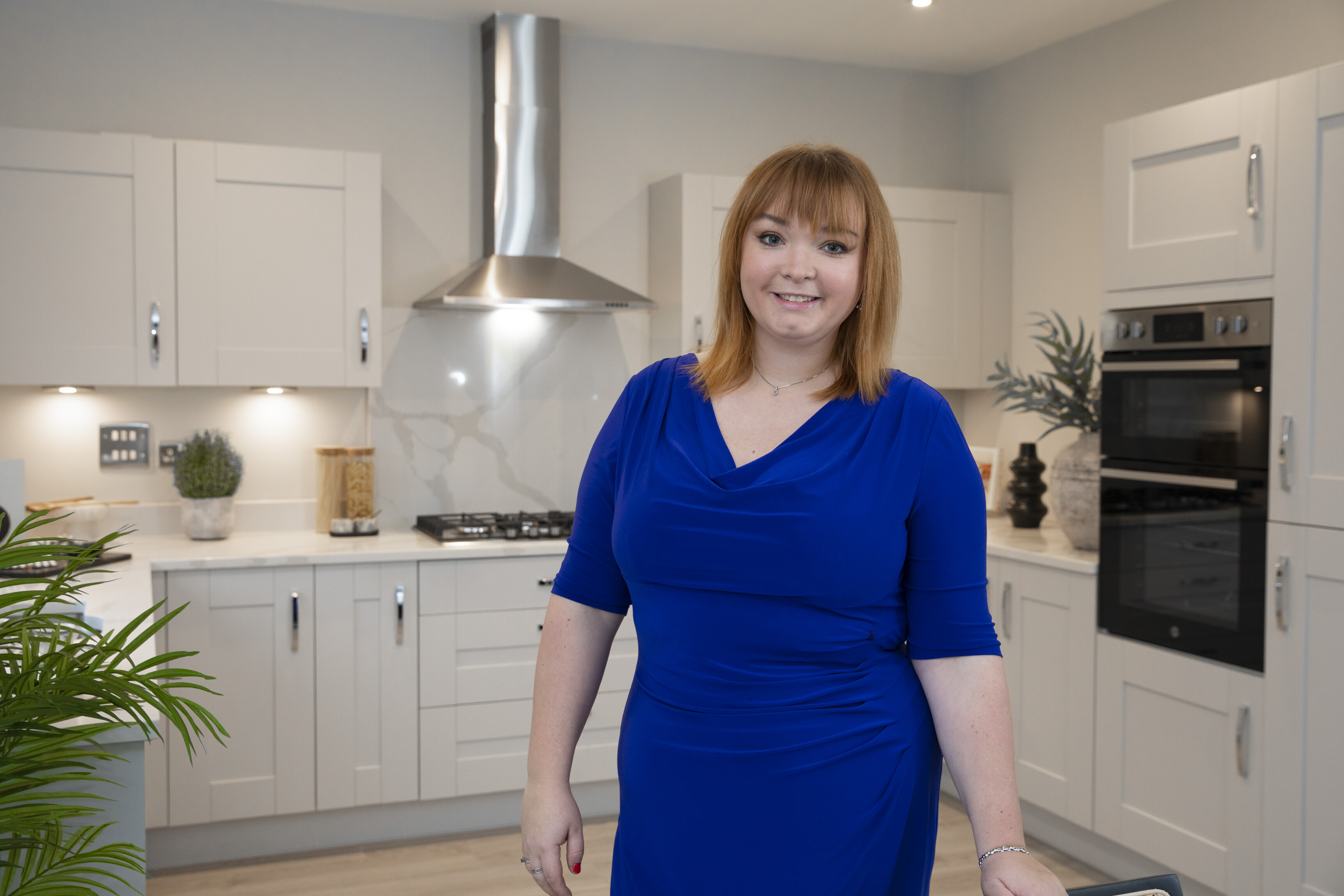 Lauren standing in show home kitchen