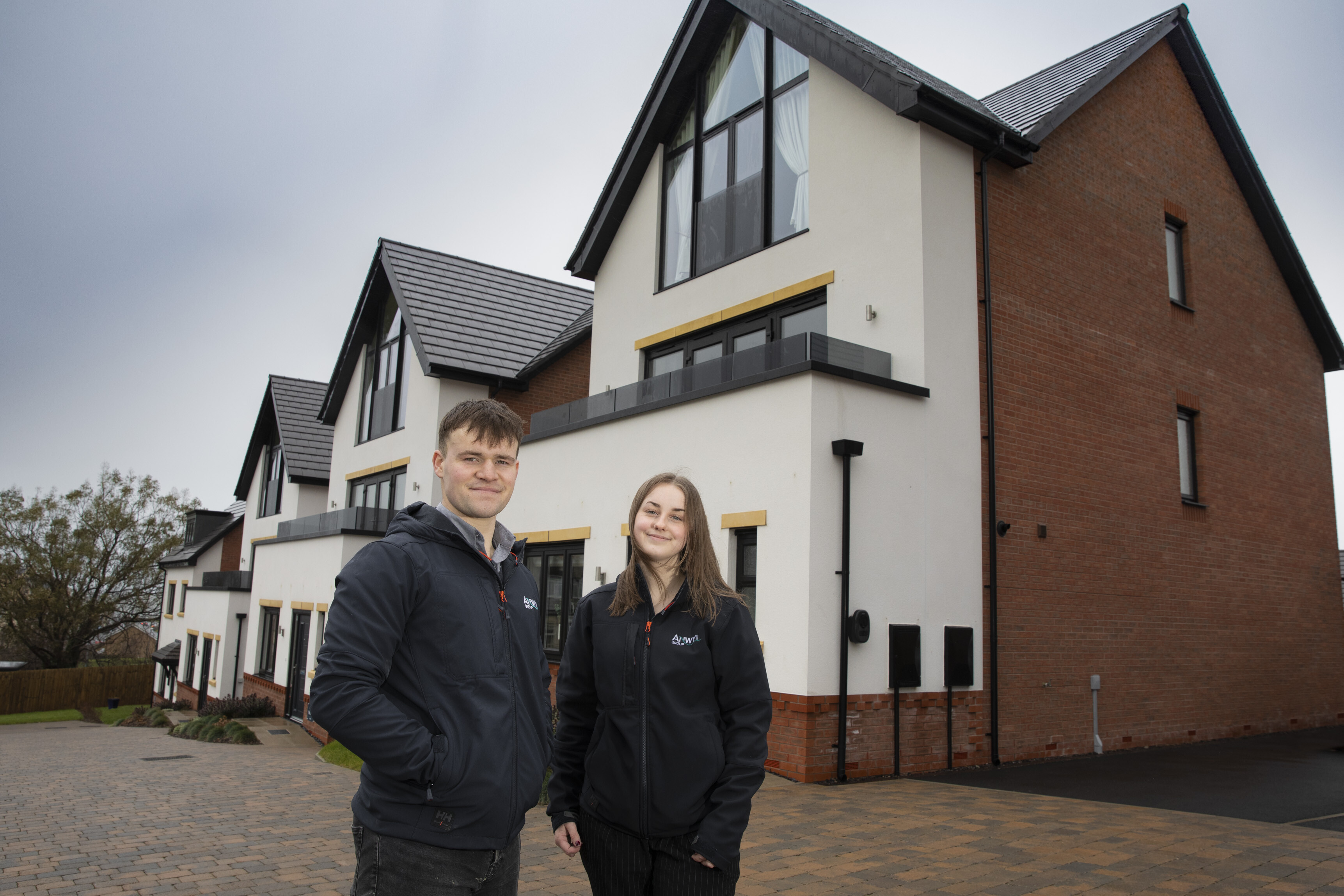 Alex Davies and Ruby Jones stand in front of show home at Parc Bodafon, Llandudno