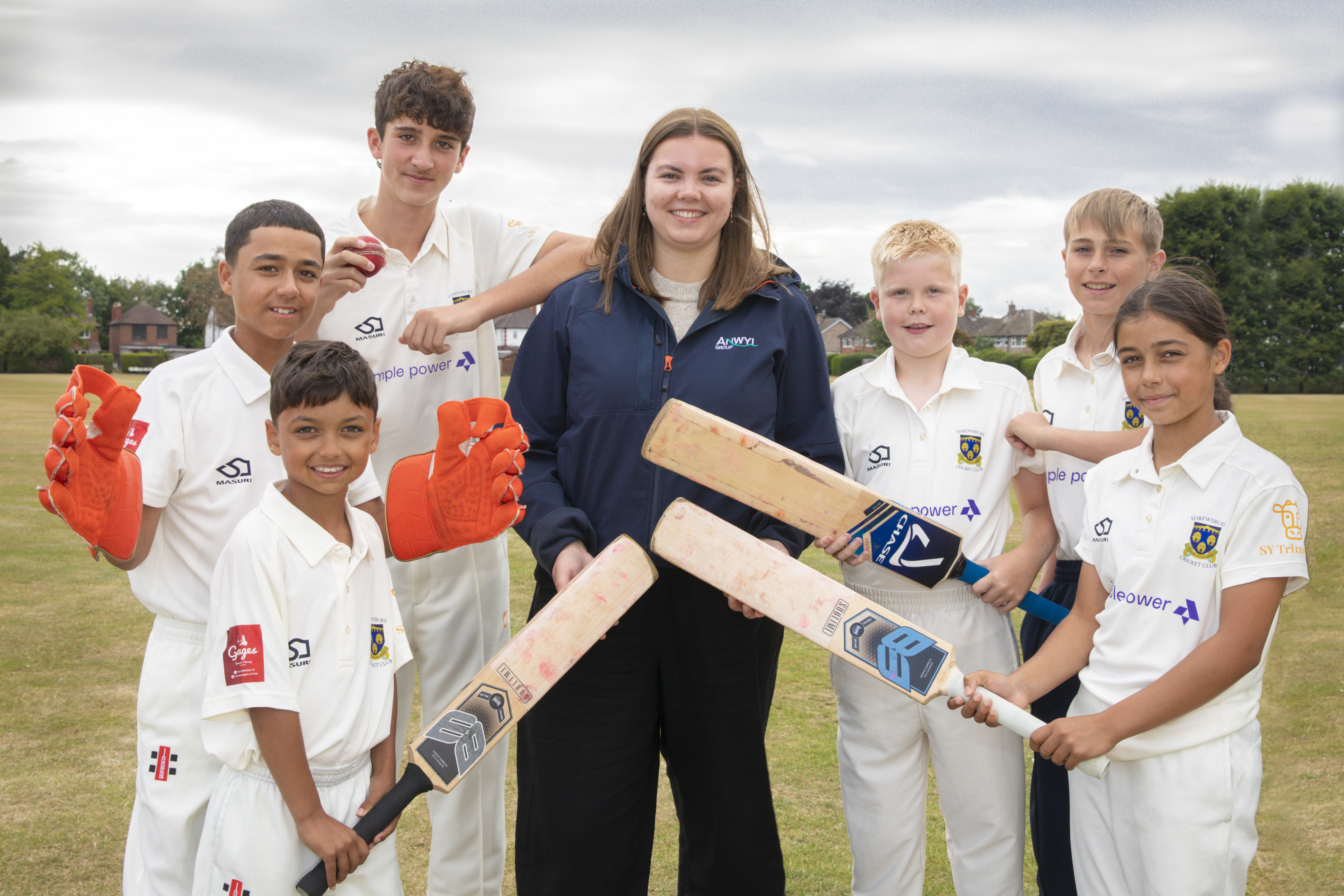 Cricket club members stood with Anwyl representative