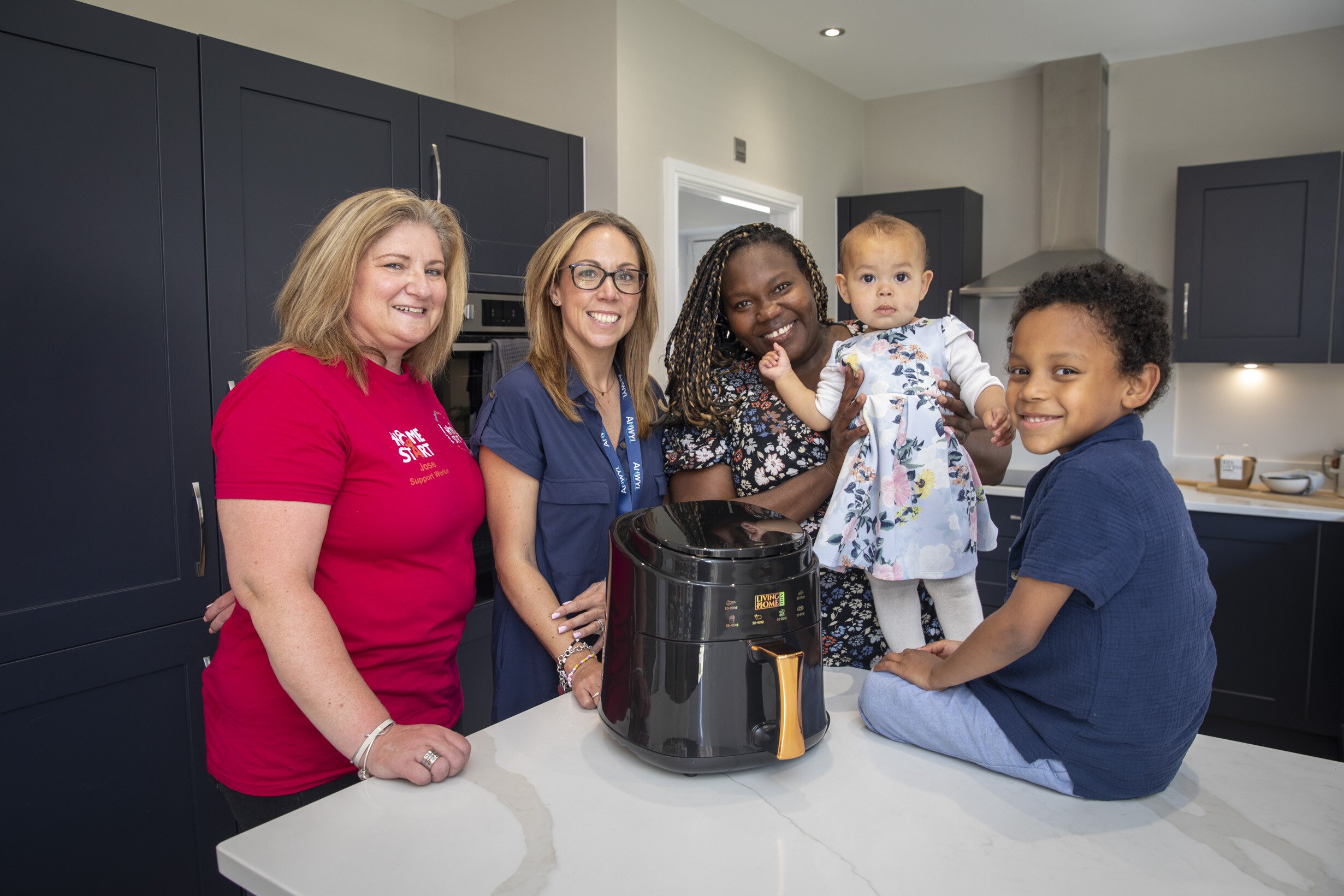 Jose Haigh, from the charity, is pictured with Anwyl area sales manager Amy Houlihan and Nelsi Suazo Lopez with children Dexter and Ansela